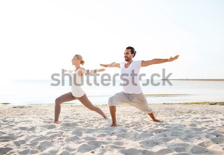 couple making yoga exercises outdoors Stock photo © dolgachov