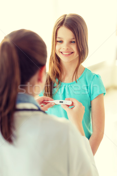 female doctor with child measuring temperature Stock photo © dolgachov