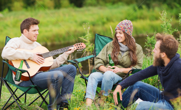 group of tourists playing guitar in camping Stock photo © dolgachov