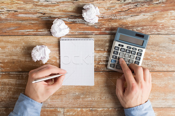 close up of hands with calculator and notebook Stock photo © dolgachov