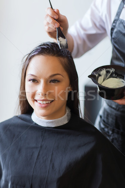 happy woman with stylist coloring hair at salon Stock photo © dolgachov