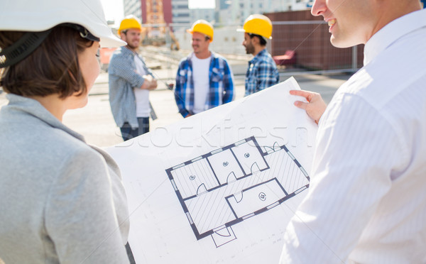 close up of architects with blueprint at building Stock photo © dolgachov