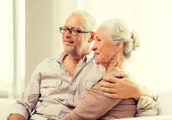 Heureux couple de personnes âgées séance canapé maison famille [[stock_photo]] © dolgachov