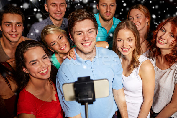friends with smartphone taking selfie in club Stock photo © dolgachov