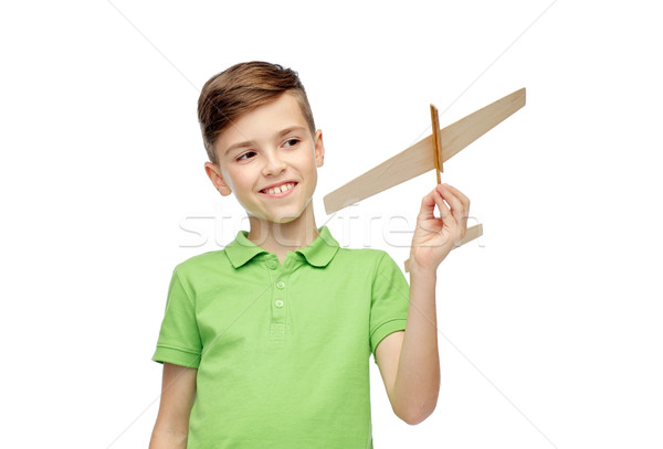 happy boy in green polo t-shirt with toy airplane Stock photo © dolgachov