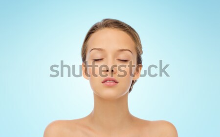 smiling young woman face and shoulders Stock photo © dolgachov