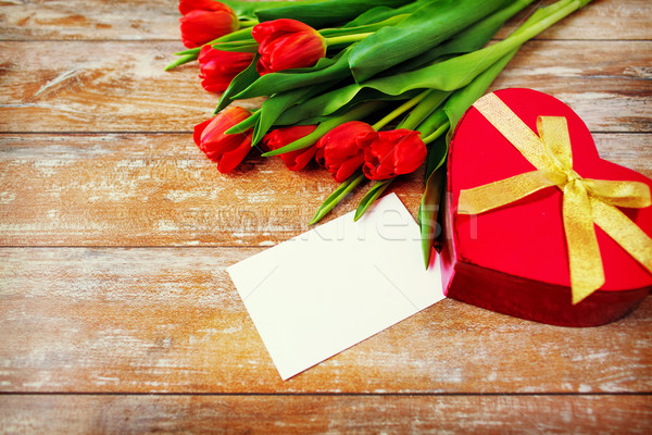 close up of red tulips, letter and chocolate box Stock photo © dolgachov