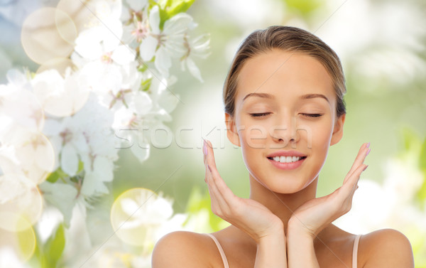 smiling young woman face and hands Stock photo © dolgachov