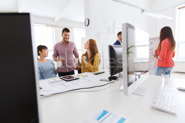 happy creative team rinking coffee at office Stock photo © dolgachov