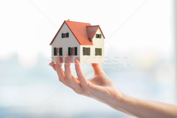 close up of hands holding house or home model Stock photo © dolgachov