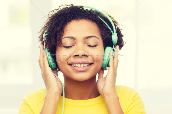 happy woman with headphones listening to music Stock photo © dolgachov