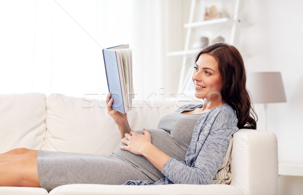 [[stock_photo]]: Heureux · femme · enceinte · lecture · livre · maison · grossesse