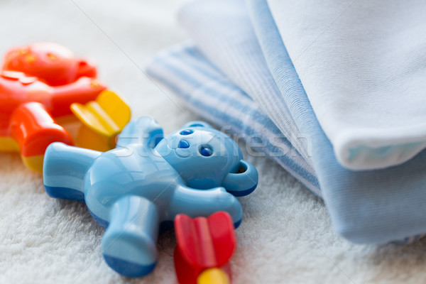 close up of baby rattle and clothes for newborn Stock photo © dolgachov