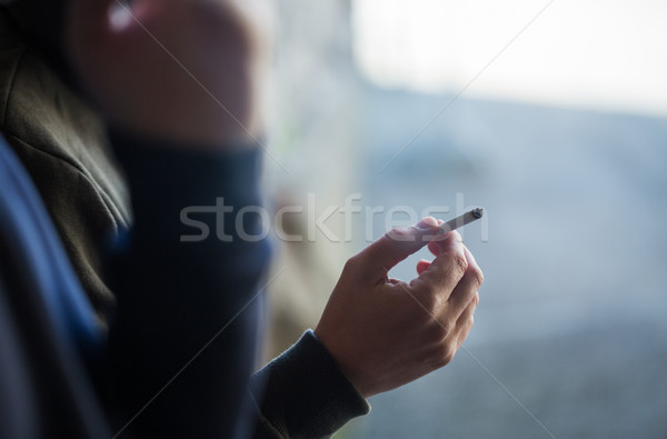 Stock photo: close up of male hand with smoking cigarette