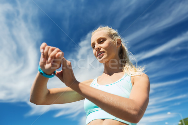 happy woman with heart rate watch and earphones Stock photo © dolgachov
