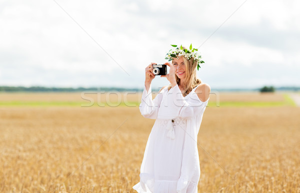 happy woman with film camera in wreath of flowers Stock photo © dolgachov