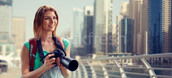 woman with backpack and camera over dubai city Stock photo © dolgachov