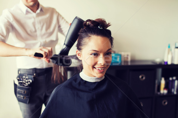 Happy Woman With Stylist Making Hairdo At Salon Stock Photo C Syda