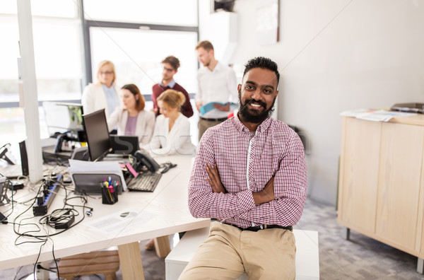 happy indian man over creative team in office Stock photo © dolgachov