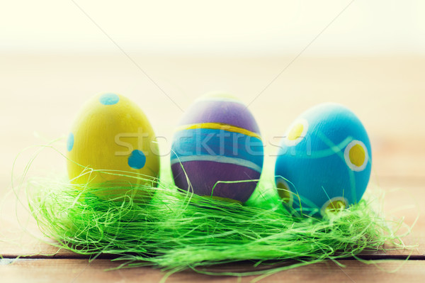 Stock photo: close up of colored easter eggs and grass