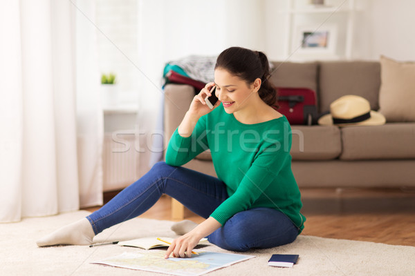 woman with travel map calling on smartphone Stock photo © dolgachov