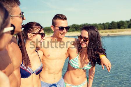 group of smiling women eating ice cream on beach Stock photo © dolgachov