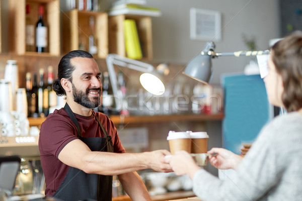 man or waiter serving customer in coffee shop Stock photo © dolgachov