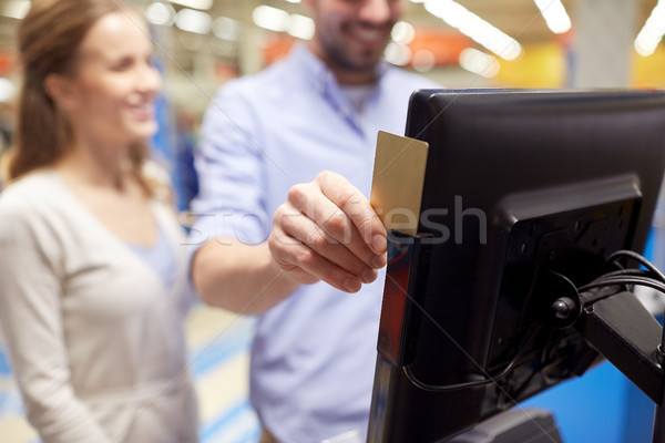 couple with customer card at store self-checkout Stock photo © dolgachov