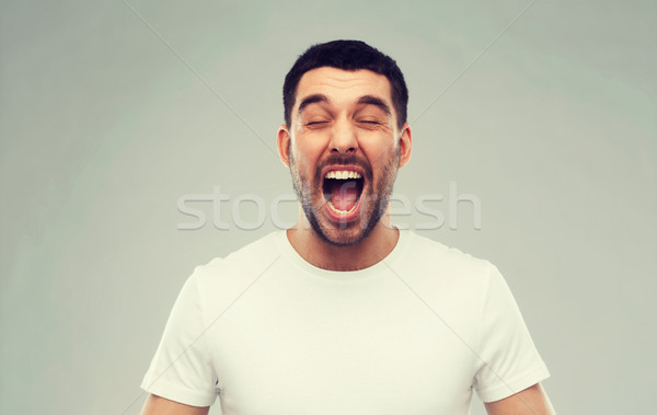 Crazy człowiek tshirt szary emocje Zdjęcia stock © dolgachov