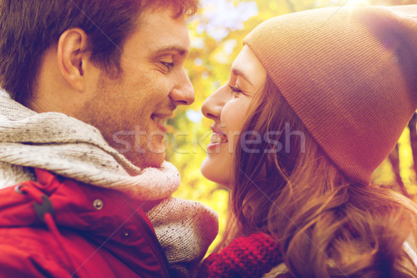 Stock photo: close up of happy young couple kissing outdoors