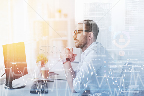 businessman in glasses sitting at office computer Stock photo © dolgachov