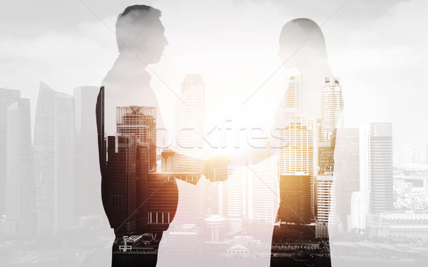 business people shaking hands over city background Stock photo © dolgachov