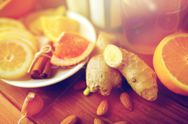 ginger, citrus fruits, tea or honey on wood Stock photo © dolgachov