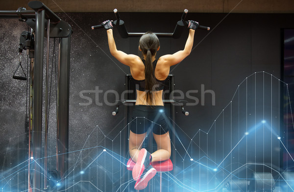 woman exercising and doing pull-ups in gym Stock photo © dolgachov