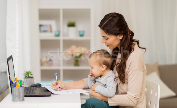 happy mother with baby and papers working at home Stock photo © dolgachov