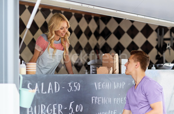 saleswoman at food truck serving male customer Stock photo © dolgachov