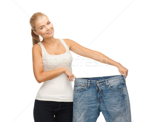 sporty woman showing big pants Stock photo © dolgachov
