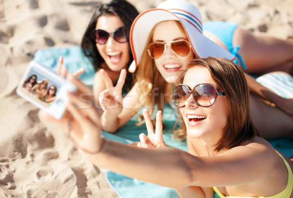 girls taking self photo on the beach Stock photo © dolgachov