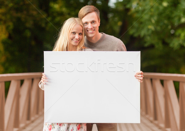 romantic couple with blank white board Stock photo © dolgachov