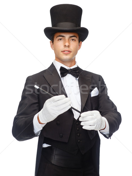 magician in top hat with magic wand showing trick Stock photo © dolgachov