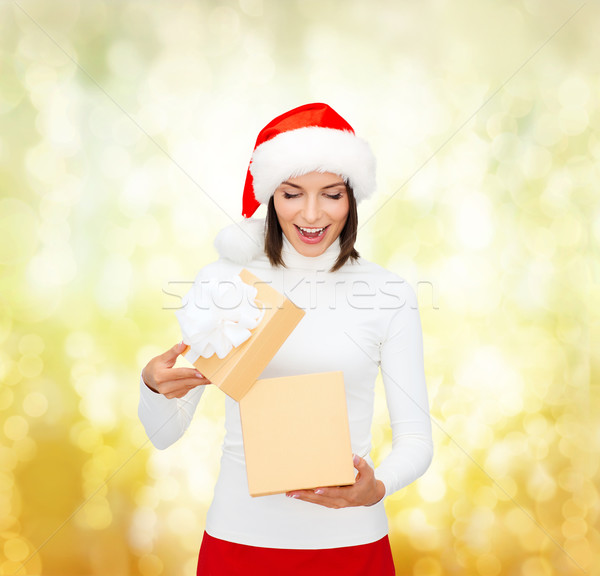 surprised woman in santa helper hat with gift box Stock photo © dolgachov