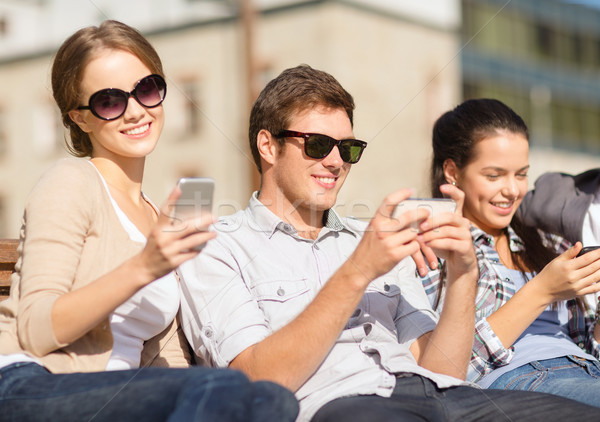 students looking at smartphones and tablet pc Stock photo © dolgachov