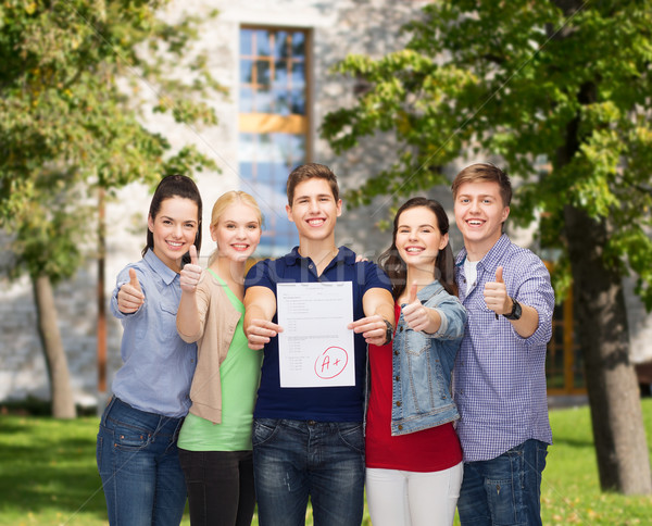 group of students showing test and thumbs up Stock photo © dolgachov