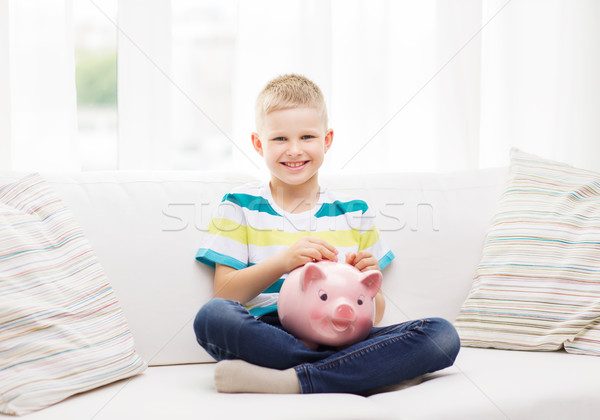 smiling little boy with piggy bank and money Stock photo © dolgachov