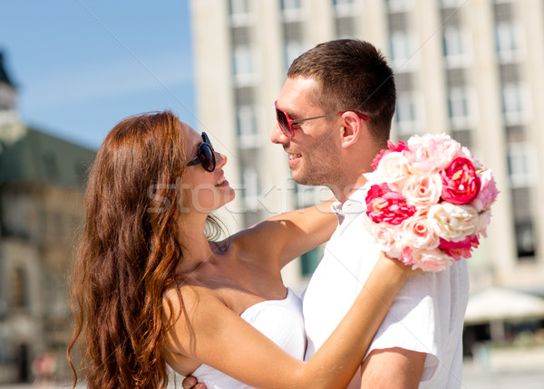 smiling couple in city Stock photo © dolgachov