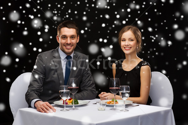 smiling couple eating main course at restaurant Stock photo © dolgachov