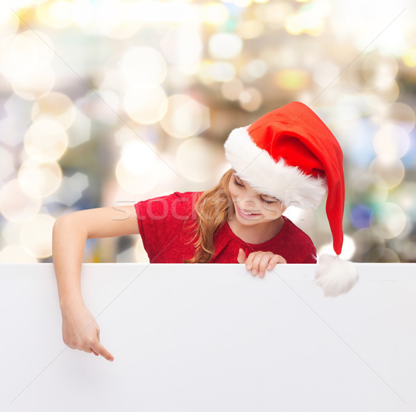 Stock photo: girl in santa helper hat with blank white board