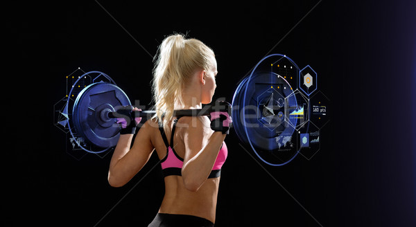 sporty woman exercising with barbell from back Stock photo © dolgachov