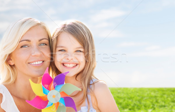 happy mother and little girl with pinwheel toy Stock photo © dolgachov