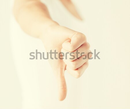 woman showing thumbs down Stock photo © dolgachov